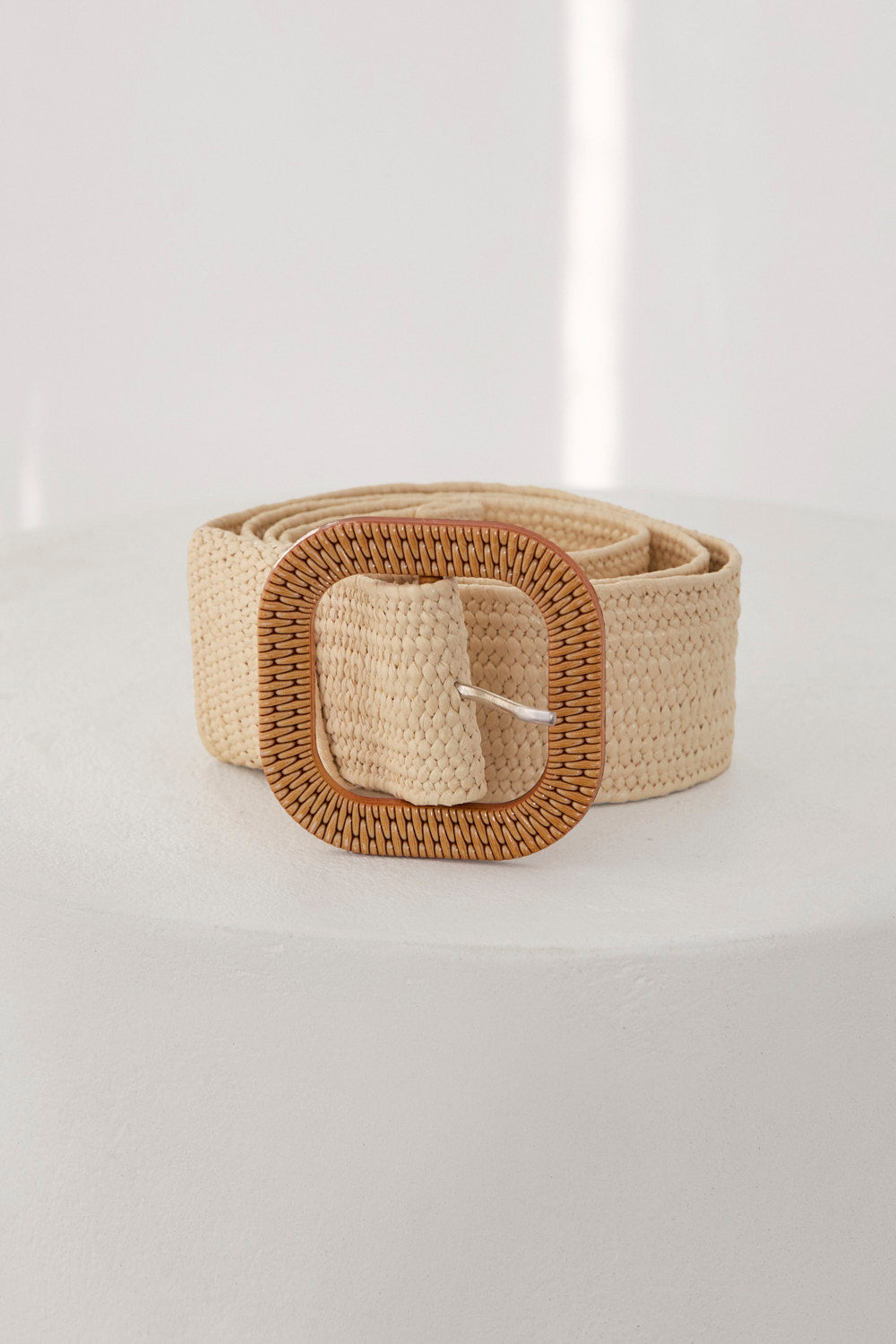 Beige woven belt on a light gray background