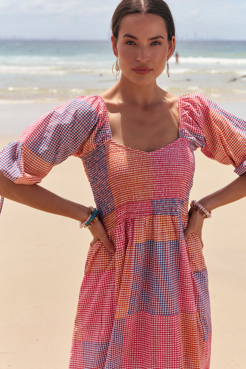 Woman in a colorful dress standing on a beach