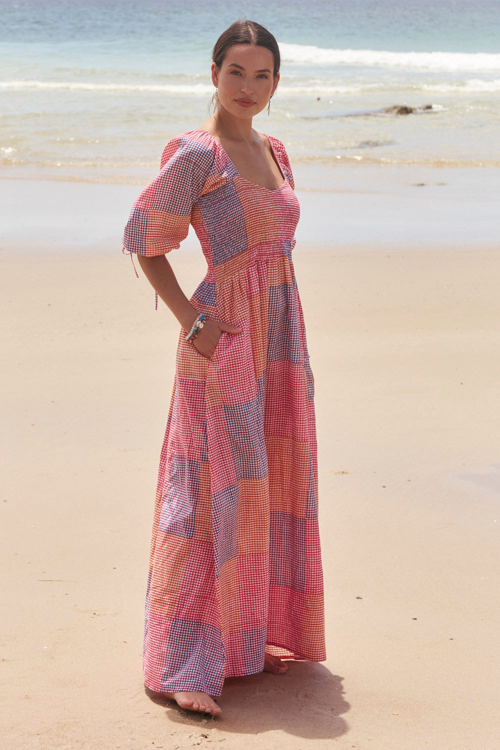Woman in a colorful dress standing on a beach