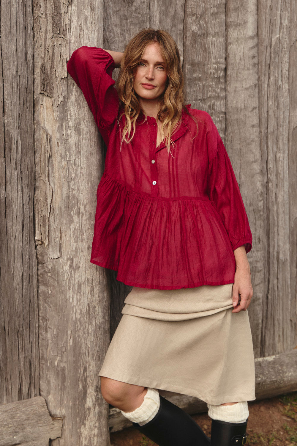 Model wearing the Coco Cotton Silk Blouse in Scarlet with round frilled neckline, Adrift Clothing