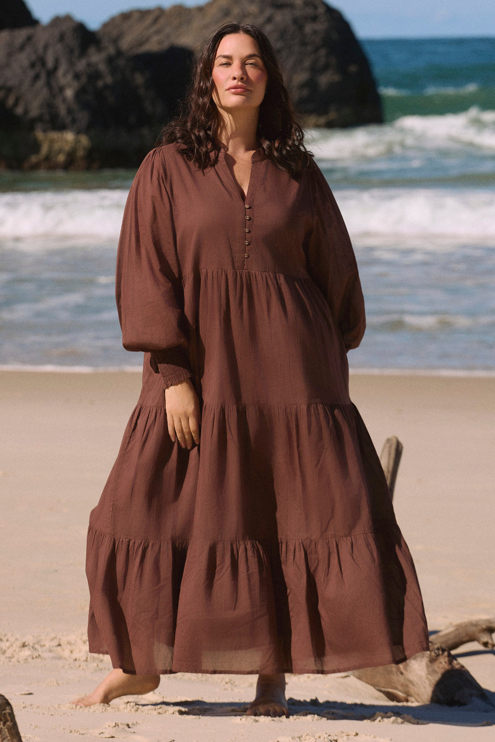 Model wearing the Sienna Billow Dress in Chocolate with long billow sleeves and wide shirred cuffs, Adrift Clothing