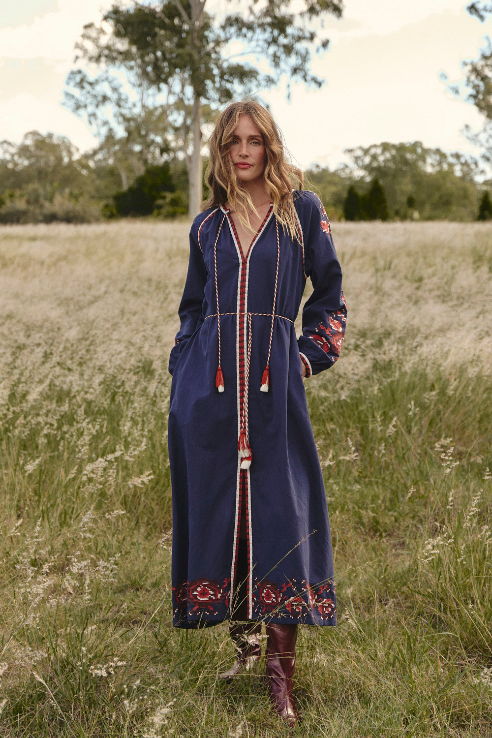 Model wearing the Robin Belted Dress in Navy Nomad with tassel tie belt cinching the waist, Adrift Clothing
